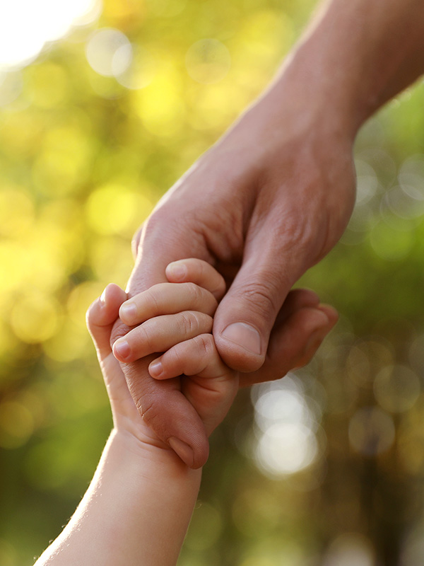 child-holding-fathers-hand
